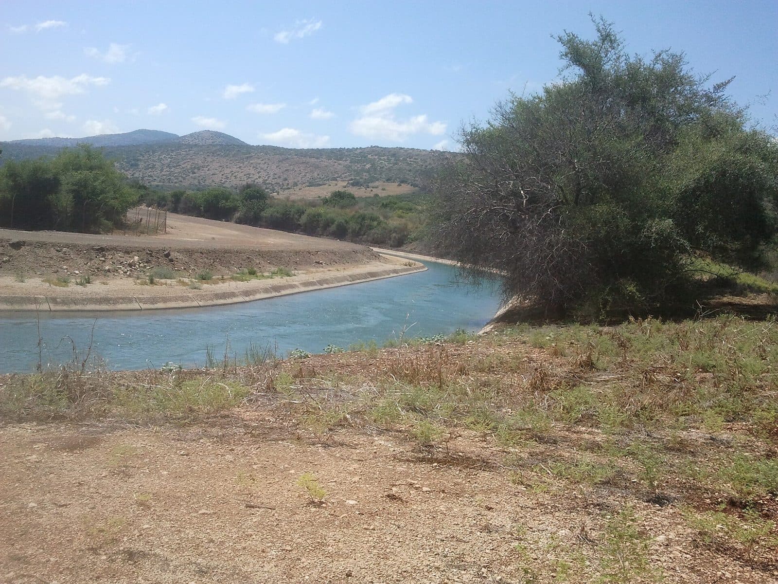 Open water conveyance canal in a rural landscape