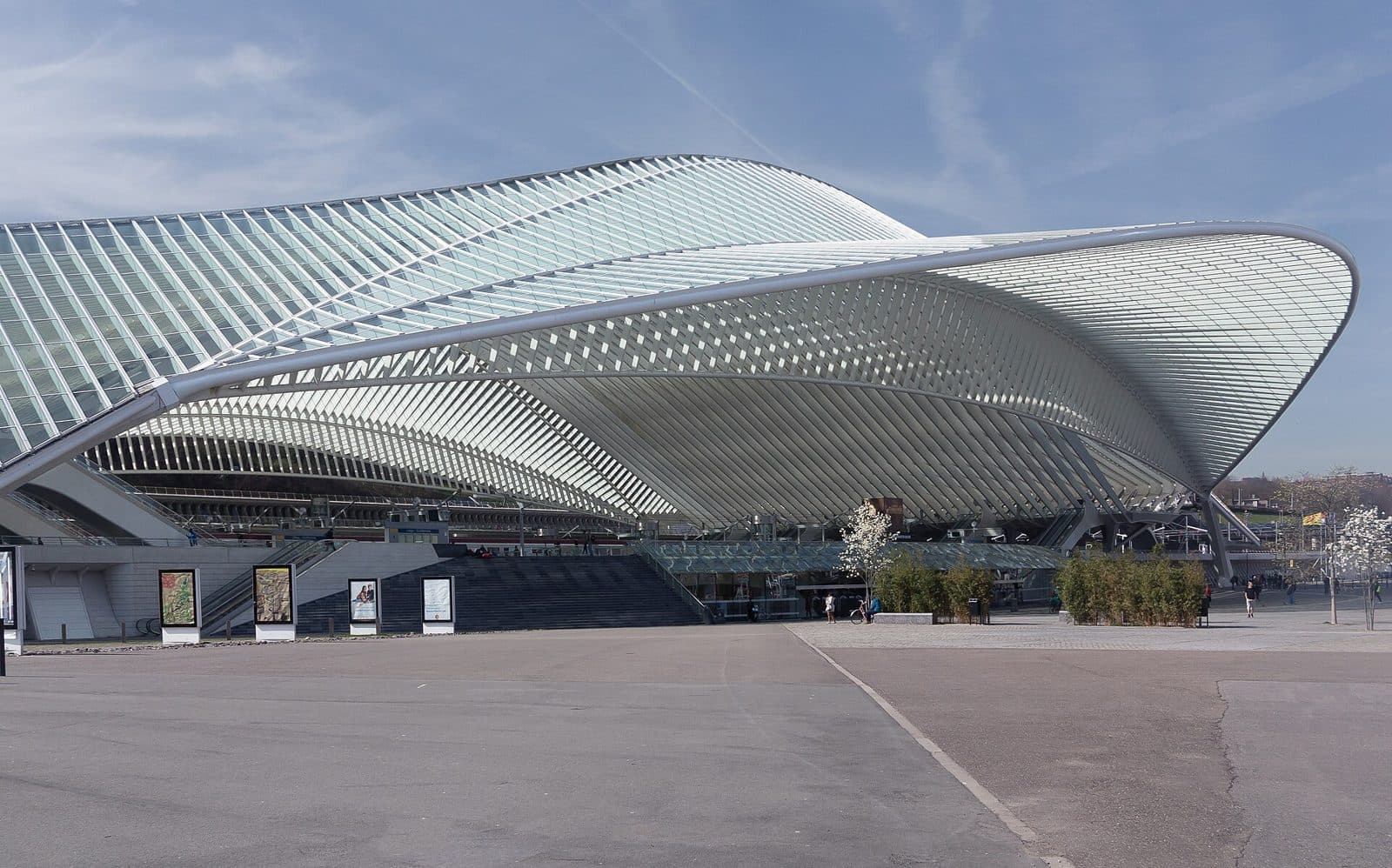 Modern railway station with a large arched canopy