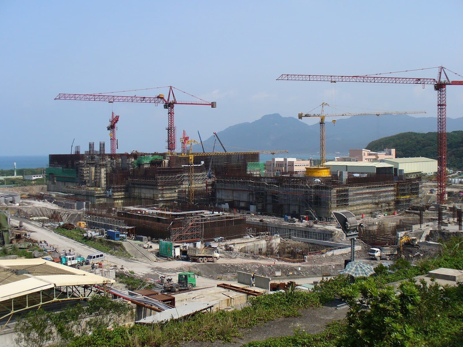Large industrial construction site with tower cranes